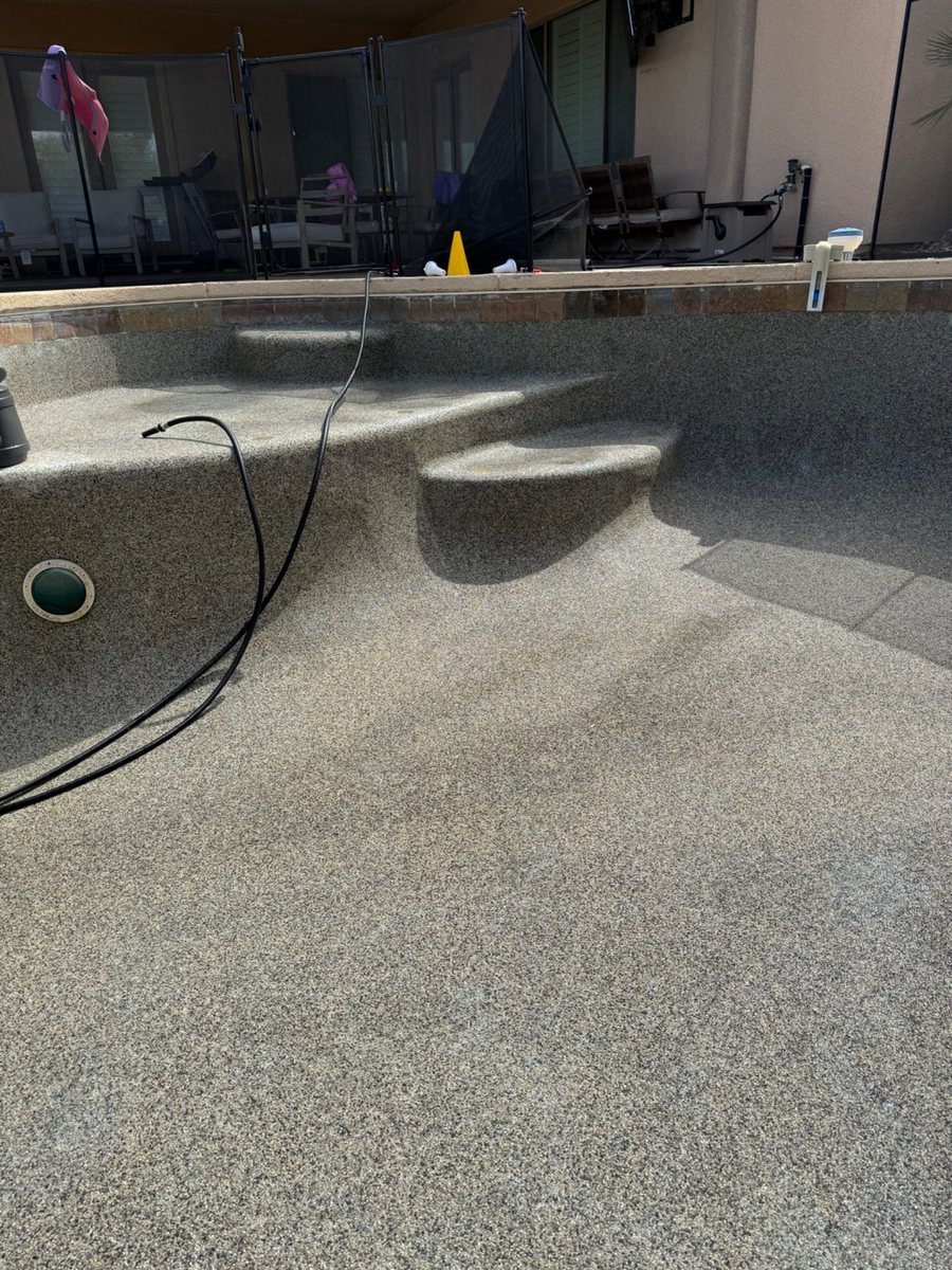 Clean residential pool surface after professional restoration work