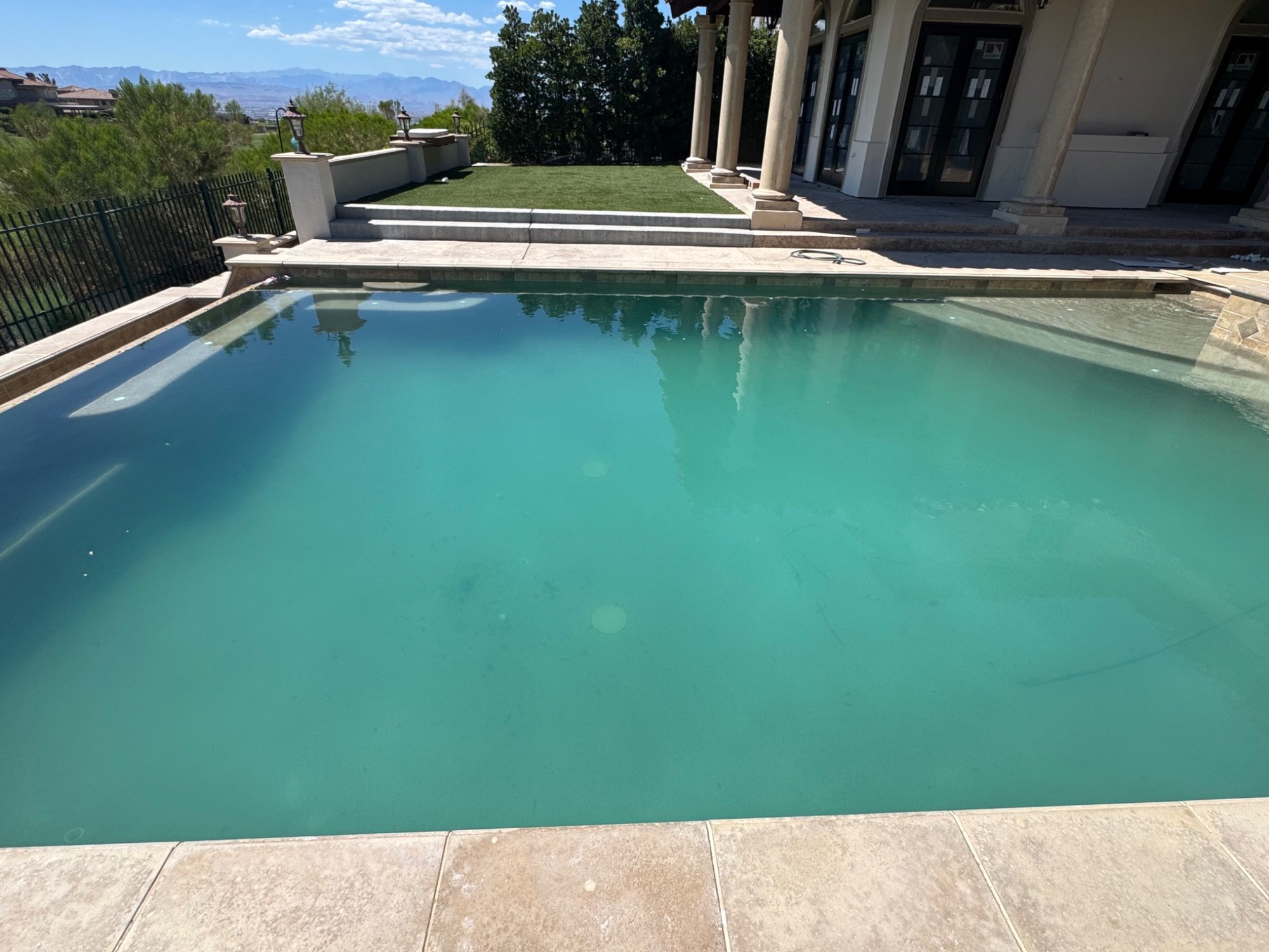 28,000-gallon pool before recovery with cloudy green water